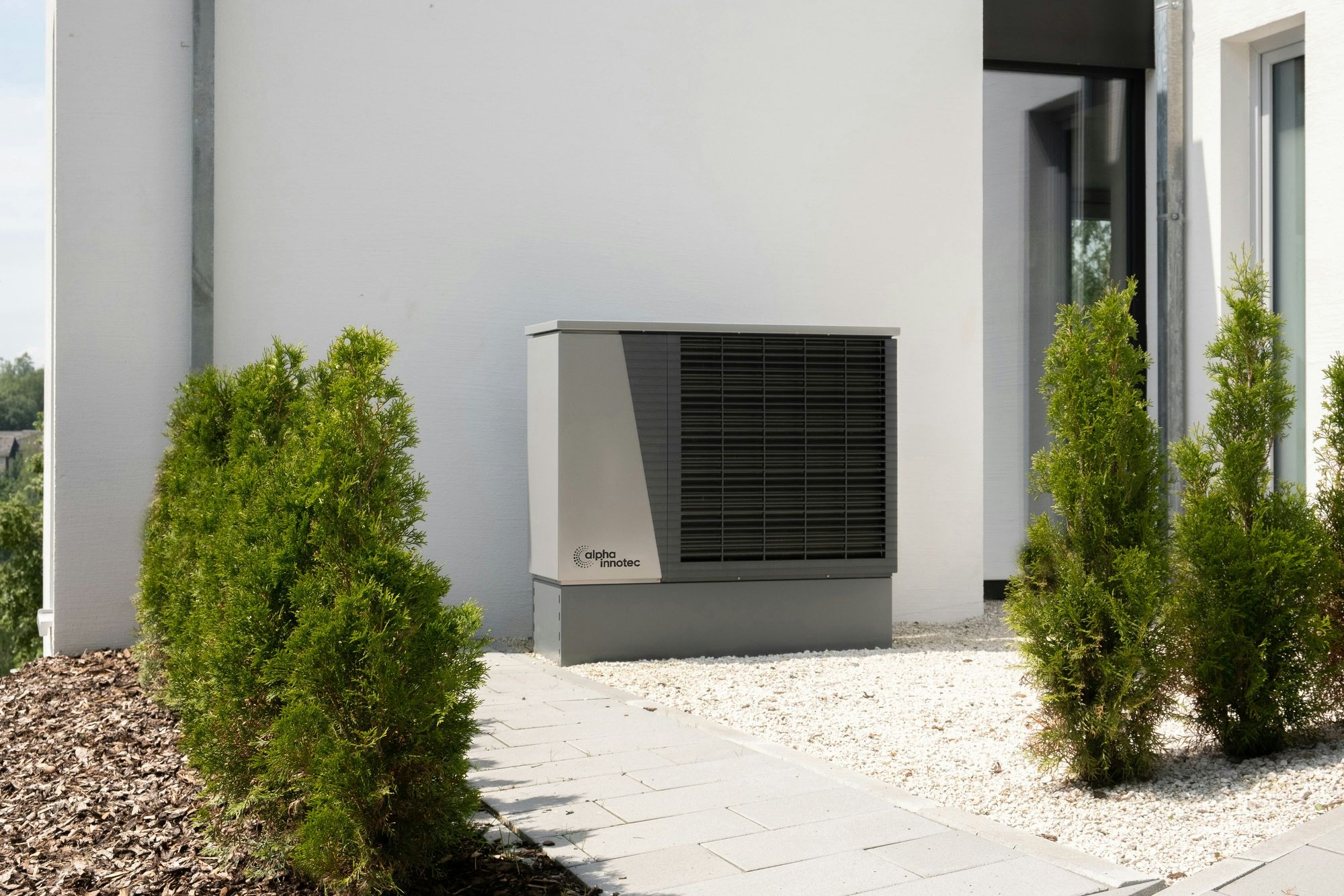 Residential heat pump installed beside a modern home